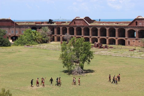 The men are escorted through historic Fort Jefferson to receive initial care and rest. Photo Source: Matthew Toro. August 4, 2015.
