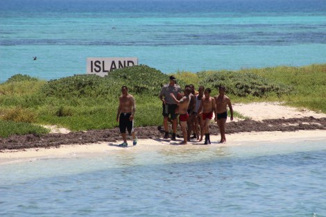 Exhausted, the Cuban immigrants walk along the Bush Key beach, to be greeted by a Dry Tortugas National Park ranger. Photo Source: Matthew Toro. August 4, 2015.